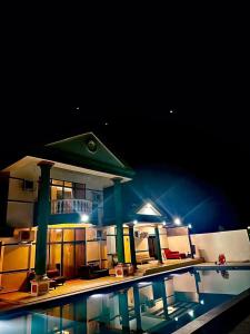 a house with a swimming pool at night at Emerald Villa in Pasir Gudang