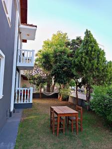 a table and chairs in a yard next to a building at Şehzade Apart Otel in Fethiye