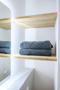 a closet with wooden shelves and blue towels at Cozy Lofts Next To Berliner Wall in Berlin