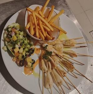 a plate of food with french fries and vegetables at Handagedara Resort & Spa in Mirissa
