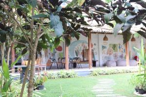 a house with chairs and a tree in a yard at Handagedara Resort & Spa in Mirissa