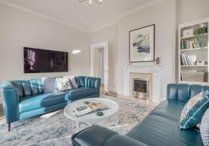 a living room with two blue couches and a fireplace at Luxury Apartment in Bowness in Bowness-on-Windermere