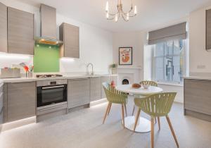 a kitchen with a table and chairs in a kitchen at Luxury Apartment in Bowness in Bowness-on-Windermere