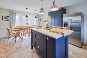 a kitchen and dining room with a refrigerator and a table at Host & Stay - Kittiwake Cottage in Bridlington +18 photos