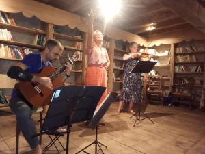 a group of people playing music in a room at La ferme des Cévennes in Florac