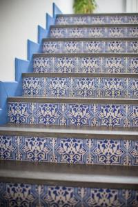 a blue and white staircase with blue and white tiles at Hotel Mignon Meublè in Sorrento