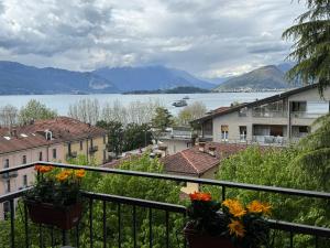 a view of the water from a balcony with flowers at La casa di Alberto lake view in Laveno