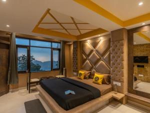 a bedroom with a large bed and a large window at The Hosteller Shimla in Shimla +26 photos
