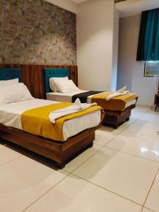 Voodi või voodid majutusasutuse Hotel Ashraya toas +6 fotot