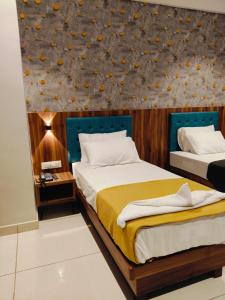 Voodi või voodid majutusasutuse Hotel Ashraya toas