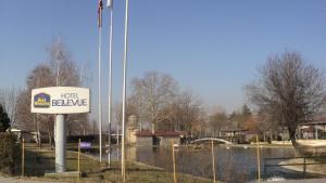 a sign that says hotel believe on a fence at Hotel Bellevue in Skopje