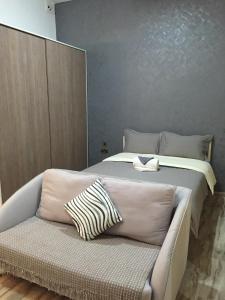 a bedroom with a bed and a couch at Senglea Apartments in Senglea