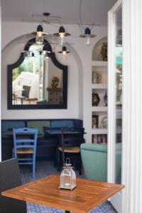 a dining room with a table and a mirror at Hotel Mignon Meublè in Sorrento
