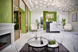 a living room with a fireplace and a table at HIDE PARK Hotel in Vinnytsya