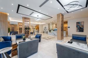 a lobby with couches and chairs in a building at Al Qasr Hotel Al Rabwah in Abha