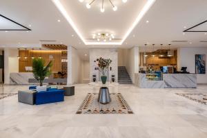 a lobby of a store with a reception desk and flowers at Al Qasr Hotel Al Rabwah in Abha +16 photos