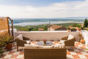 a patio with chairs and a table on a roof at Traditional House, view on lake, yoga, sauna R4543 in Sorradile