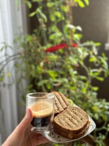 a person holding a glass of wine and a plate of bread at Sheraton Luxury Villa in Baku