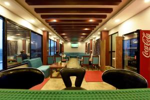 a waiting room with chairs and a table in a restaurant at Hotel Harmony in Kathmandu