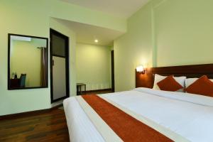 a bedroom with a large bed and a large mirror at Hotel Harmony in Kathmandu