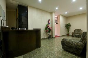 a lobby with a reception desk and a chair at Hotel Harmony in Kathmandu