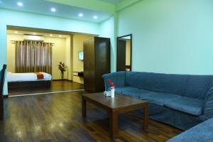 a living room with a couch and a bed at Hotel Harmony in Kathmandu
