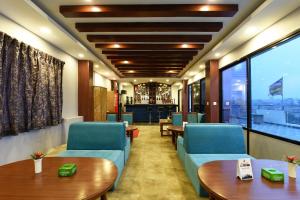 a waiting room with couches and tables and windows at Hotel Harmony in Kathmandu