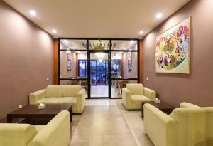 a waiting room with couches and chairs and a table at Hotel Harmony in Kathmandu
