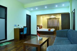 a living room with a couch and a bed at Hotel Harmony in Kathmandu