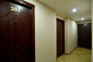 a hallway with a door and two elevators at Hotel Harmony in Kathmandu