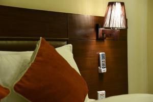 a remote control on the head board of a bed at Hotel Harmony in Kathmandu