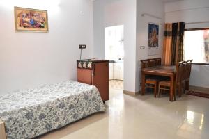 a bedroom with a bed and a table and a desk at Sharma in Shimla