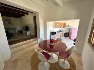 a dining room with a table and white chairs at Gite Les Robiniers in Beaumont-de-Pertuis +27 photos