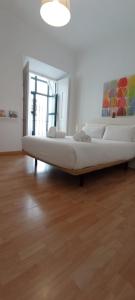 Łóżko lub łóżka w pokoju w obiekcie Casas y Patios de Sevilla