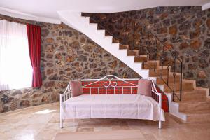 a room with a bed and a stone wall at Villa Oasis Taşın Zarafeti,Modern Rahatlık in Dalaman +34 photos