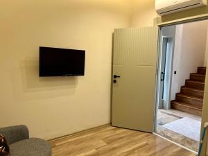 a room with a flat screen tv on the wall at Green Park Villa in Kemer