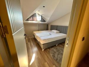 a small bedroom with a bed in a attic at Green Park Villa in Kemer