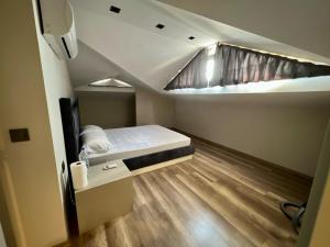 a small room with a bed and a window at Green Park Villa in Kemer +20 photos