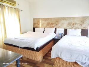 Krevet ili kreveti u jedinici u okviru objekta Siddhartha Kuti Resort