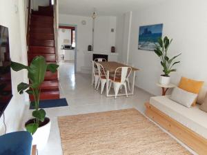a living room with a table and a couch at La Casa de Boo in Boó de Piélagos