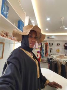 a woman wearing a cowboy hat in a store at Zanzibar,Fumbatown 2 Bed Ocean view Apartment in Mchamba Wima +57 photos