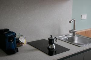 a kitchen counter with a sink and a coffee cup at La caldera in San Giuseppe Vesuviano