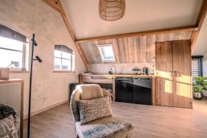 una cucina con divano e sedia in una camera di B&B Country Suite Den Oord a Terwolde