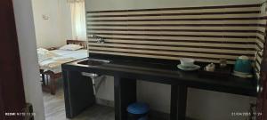 a bathroom with a sink and a bed at Jacinta's - By the beach - Cruz's place in Calangute