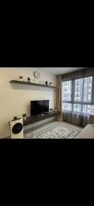 a living room with a television and a window at AQ HOME at iSUITE, iCity, Shah Alam HomestayBnB in Kampong Padang Jawa