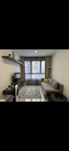 a living room with a couch and a window at AQ HOME at iSUITE, iCity, Shah Alam HomestayBnB in Kampong Padang Jawa