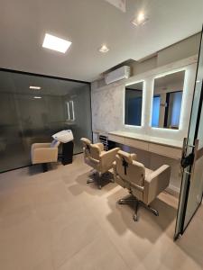 a salon with two chairs and a waiting room at Luxor residence in Laguna +21 photos