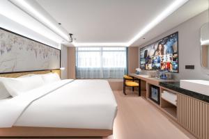 Voodi või voodid majutusasutuse Liuxiang Shangcui Hotel toas