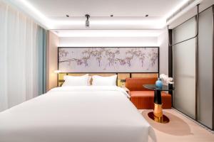 Voodi või voodid majutusasutuse Liuxiang Shangcui Hotel toas