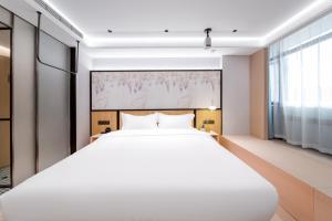 Voodi või voodid majutusasutuse Liuxiang Shangcui Hotel toas